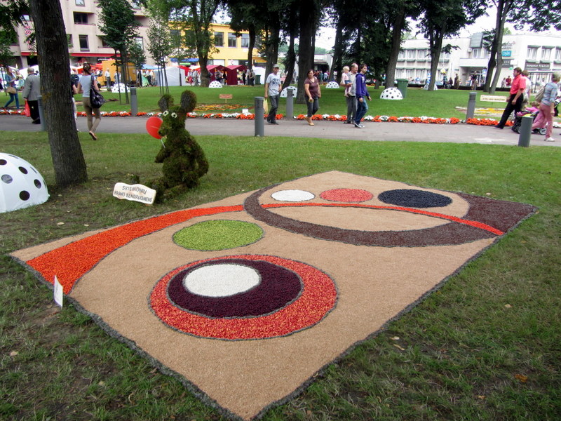Skiemonių kaimo bendruomenės kompozicija: kilimas ir jį saugantis floristinis peliukas.